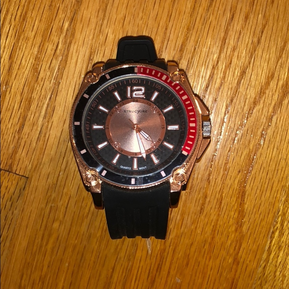 A gold and black watch that’s never been worn.